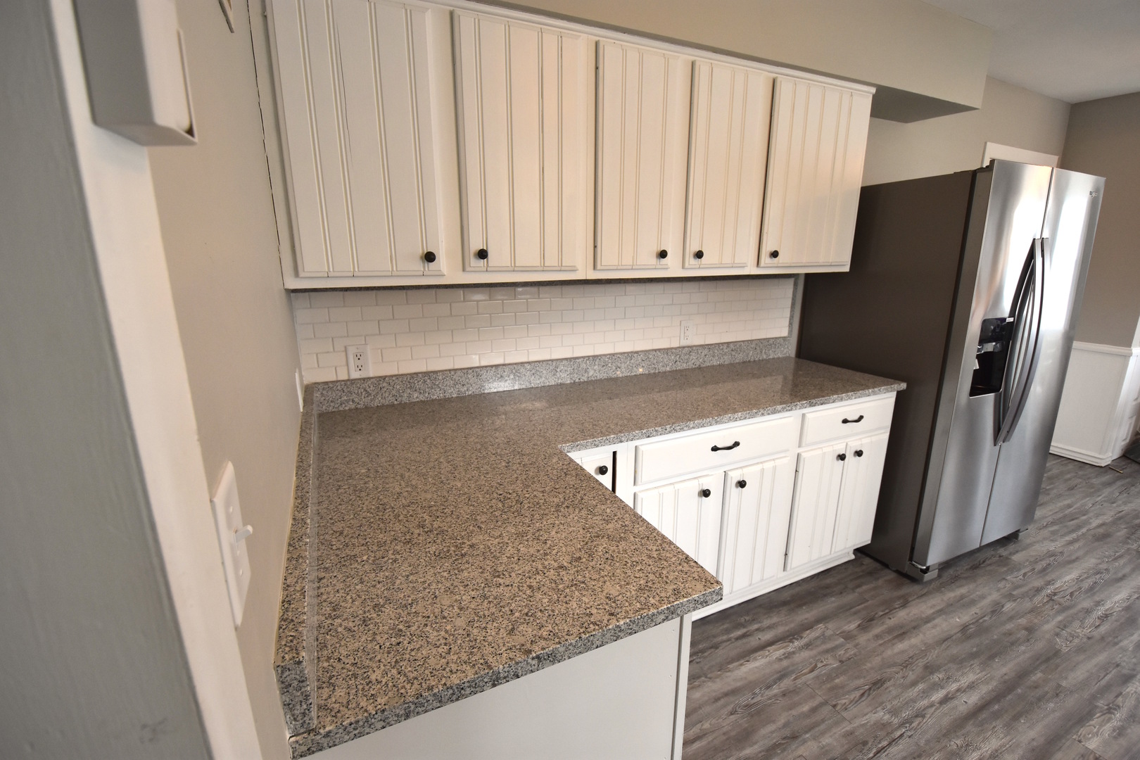 714 Normal Road DeKalb, IL 60115 - Photo 5 of 15 a kitchen with stainless steel appliances white cabinets and a refrigerator