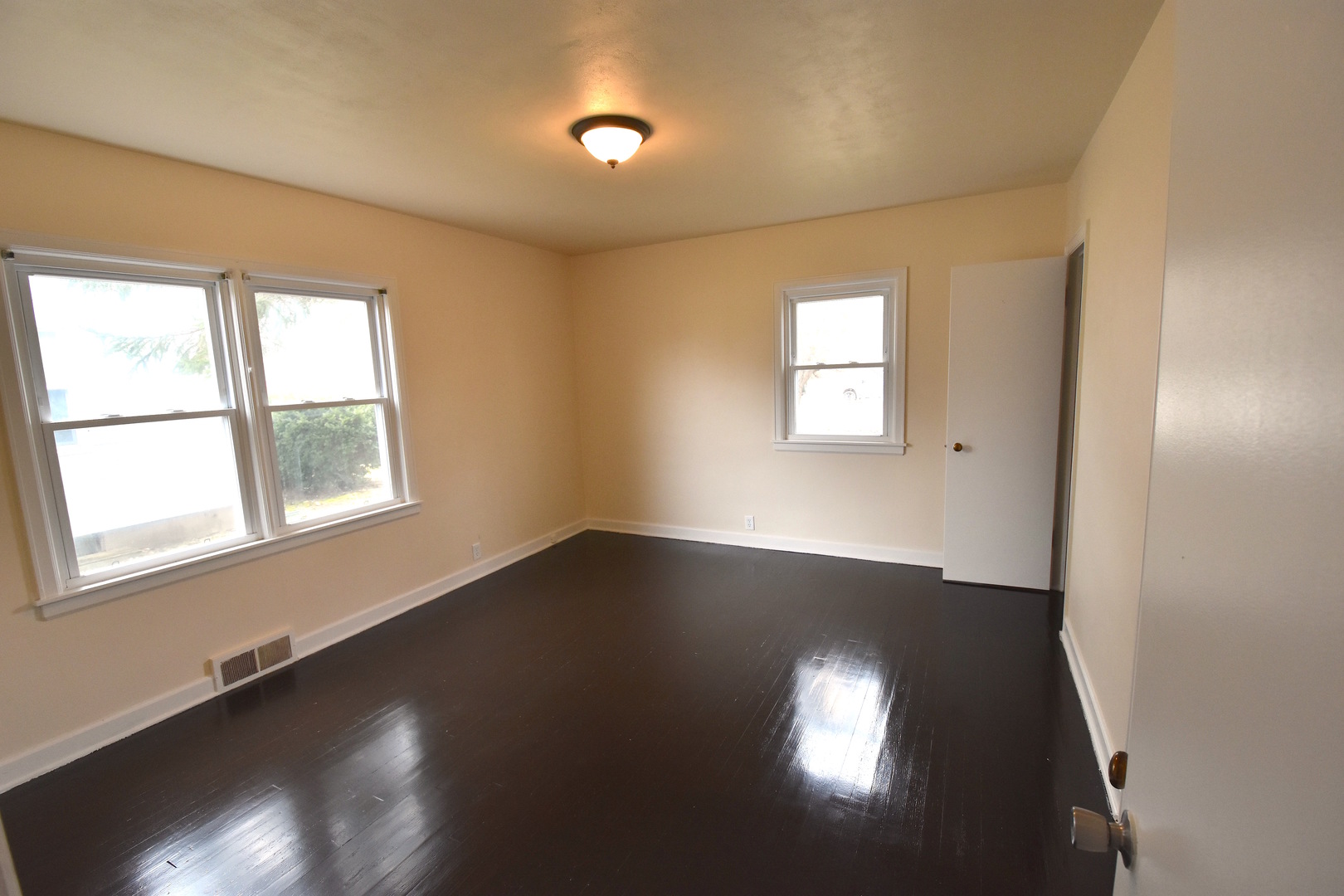 714 Normal Road DeKalb, IL 60115 - Photo 7 of 15 an empty room with wooden floor and windows