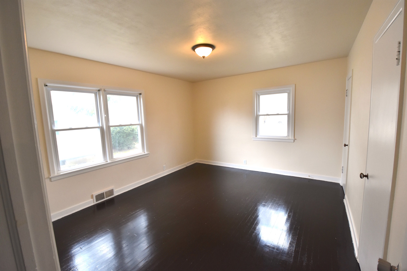714 Normal Road DeKalb, IL 60115 - Photo 9 of 15 an empty room with wooden floor and windows