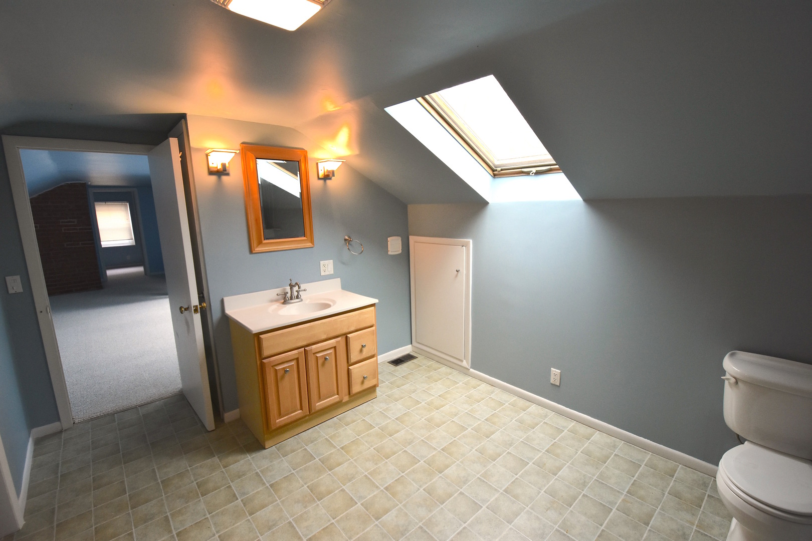 714 Normal Road DeKalb, IL 60115 - Photo 10 of 15 a bathroom with a sink a toilet and mirror
