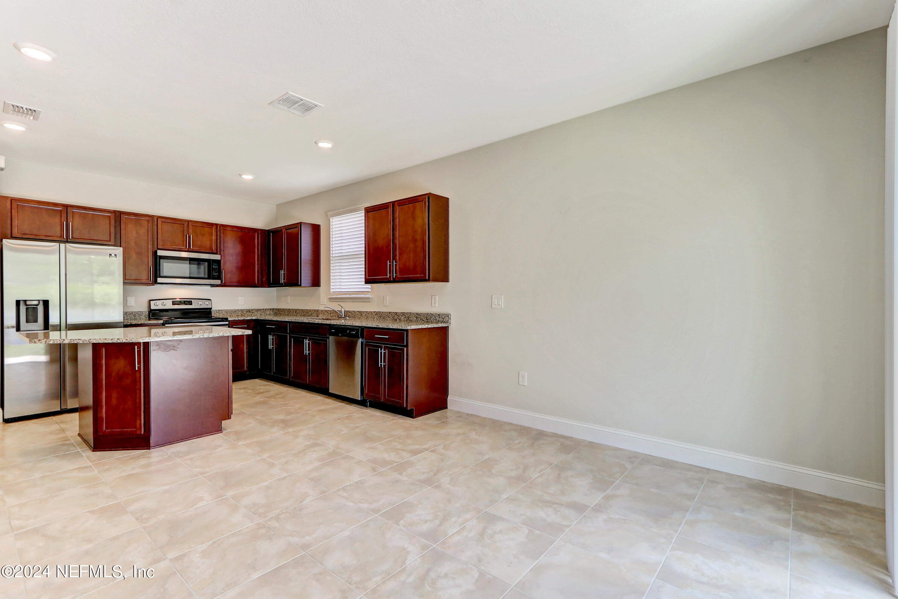 14454 Spring Light Circle Jacksonville, FL 32226 - Photo 12 of 37 a kitchen with stainless steel appliances granite countertop a stove a sink dishwasher and a refrigerator with wooden cabinets
