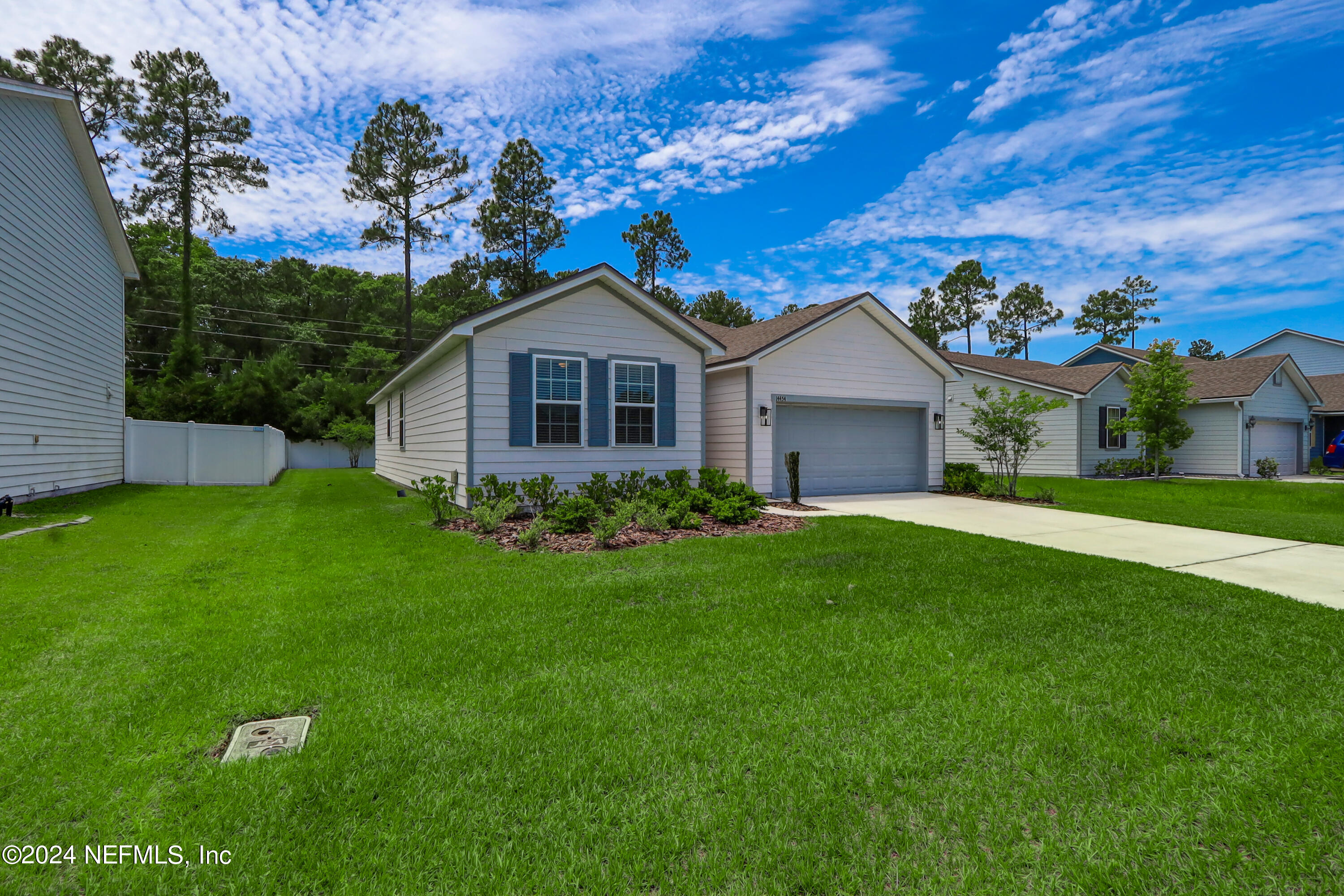 14454 Spring Light Circle Jacksonville, FL 32226 - Photo 2 of 37 a front view of a house with a garden