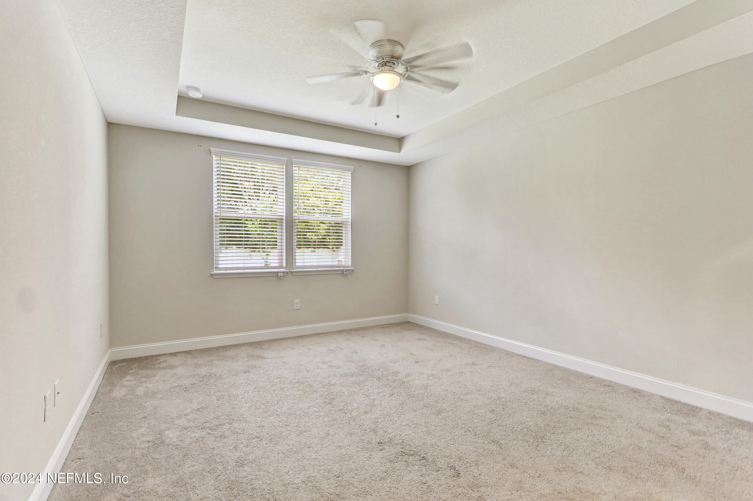 14454 Spring Light Circle Jacksonville, FL 32226 - Photo 22 of 37 an empty room with windows and ceiling fan