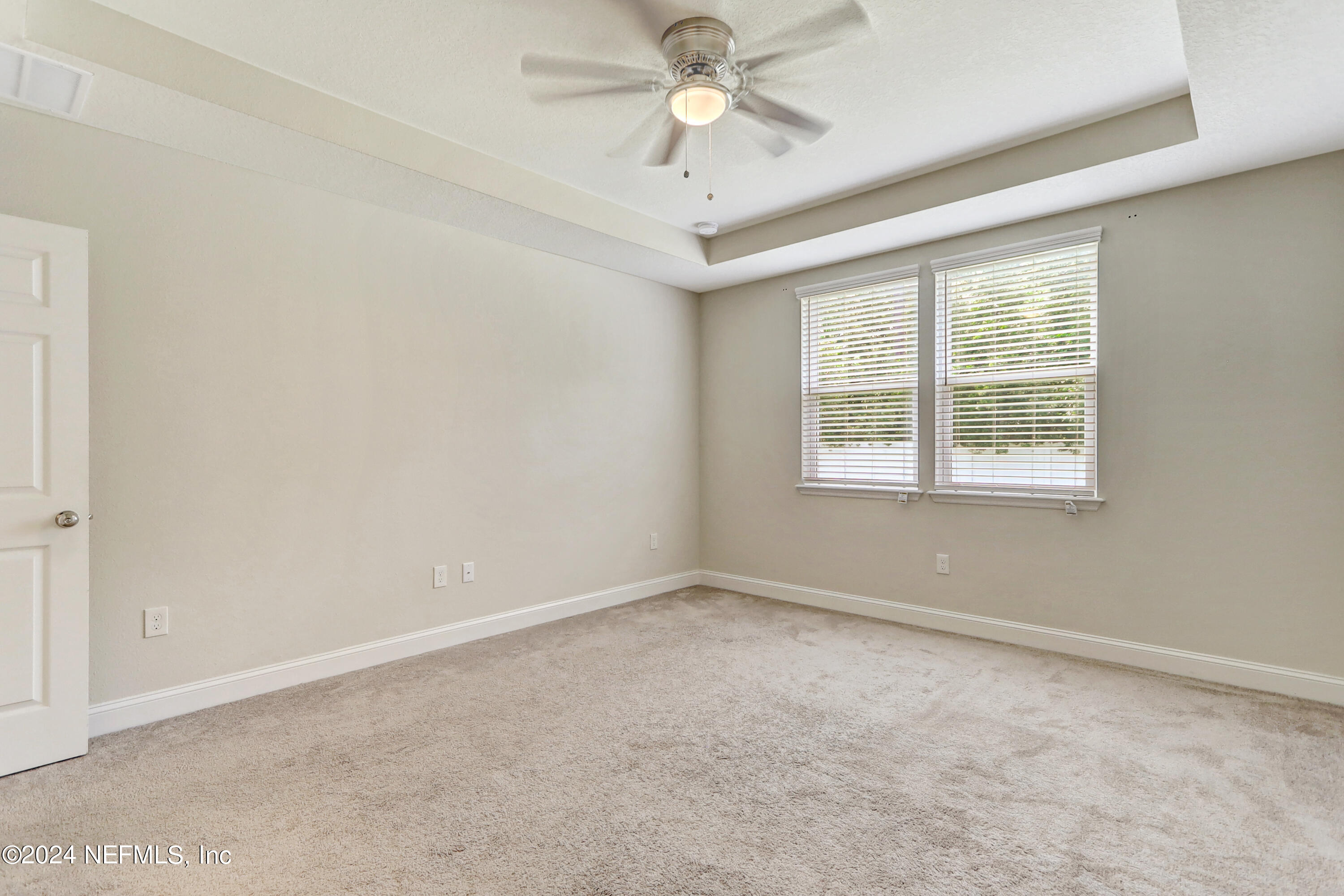 14454 Spring Light Circle Jacksonville, FL 32226 - Photo 25 of 37 an empty room with a window and a fan