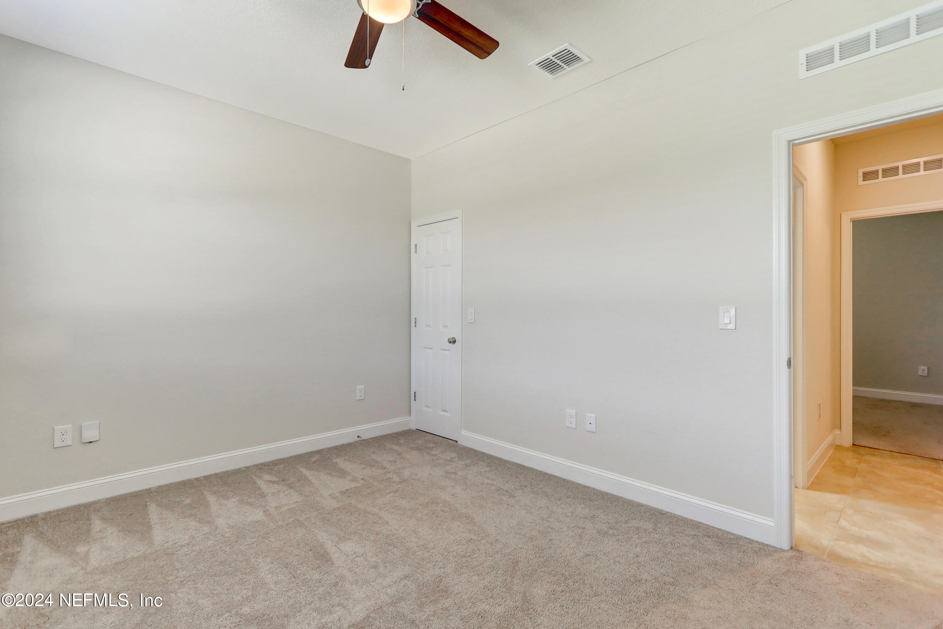 14454 Spring Light Circle Jacksonville, FL 32226 - Photo 30 of 37 an empty room with ceiling fan and window