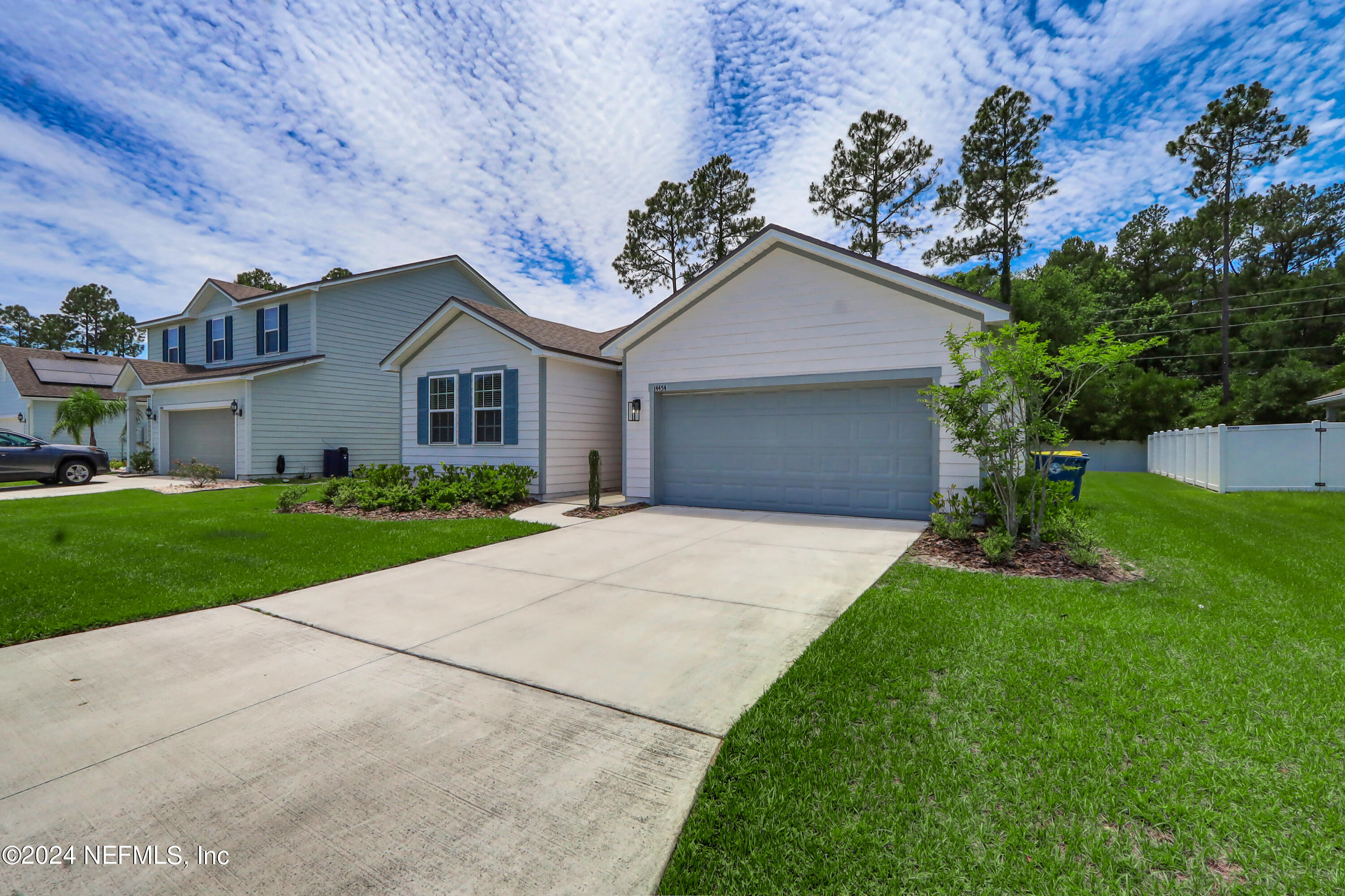 14454 Spring Light Circle Jacksonville, FL 32226 - Photo 3 of 37 a front view of a house with a yard