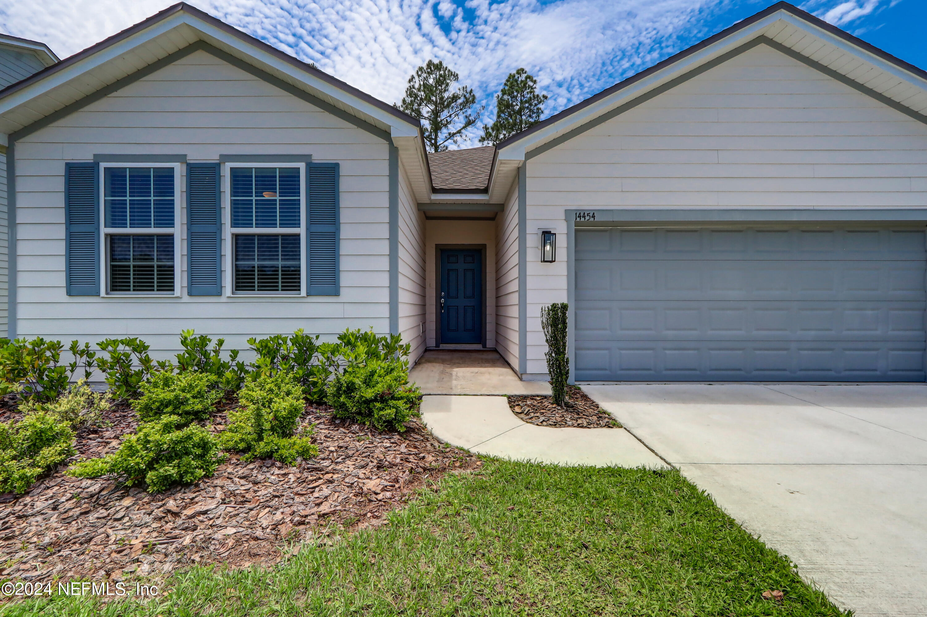 14454 Spring Light Circle Jacksonville, FL 32226 - Photo 4 of 37 a front view of a house with garden