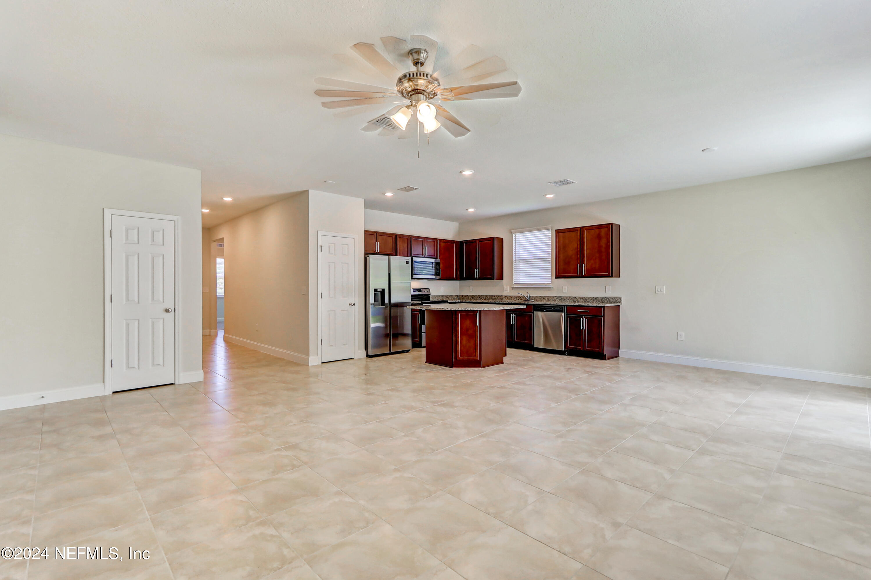 14454 Spring Light Circle Jacksonville, FL 32226 - Photo 10 of 37 an empty room with kitchen and ceiling fan