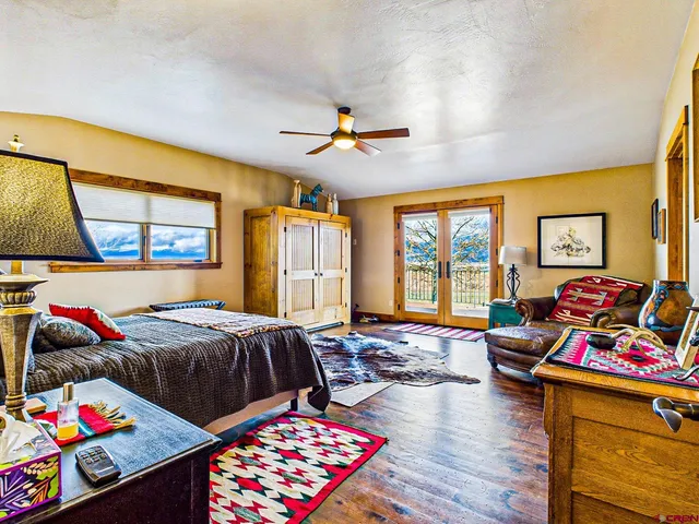 a bedroom with furniture and a flat screen tv