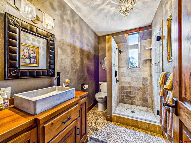 a bathroom with a double vanity sink mirror and shower