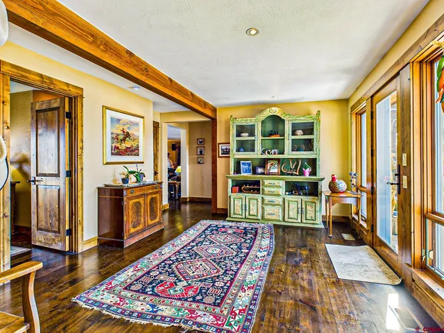 a bedroom with furniture and a rug