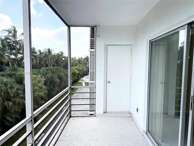 a view of a balcony with wooden floor