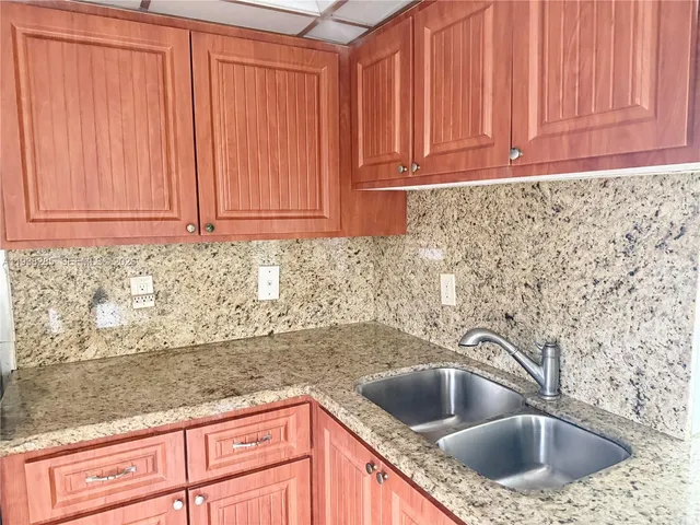 a kitchen with granite countertop a sink and a sink