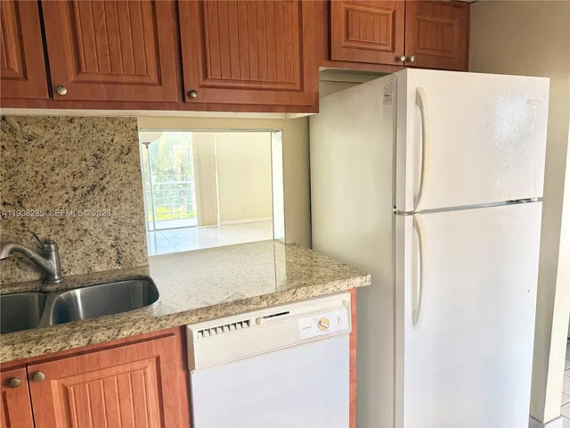 a white refrigerator freezer sitting inside of a kitchen