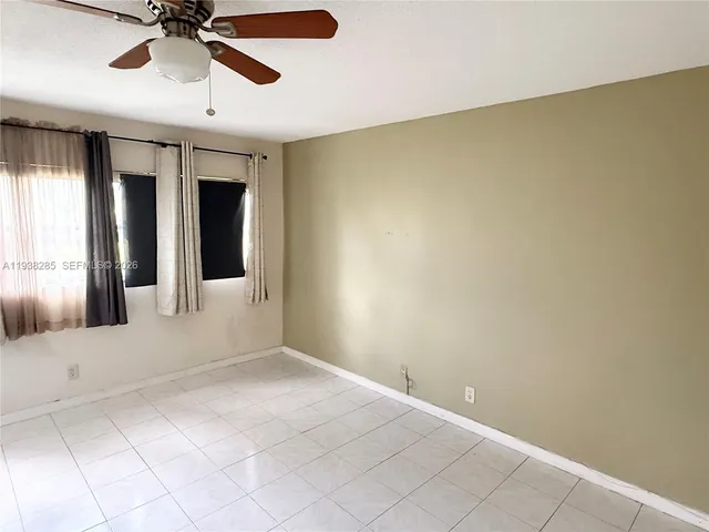 an empty room with entrance and windows