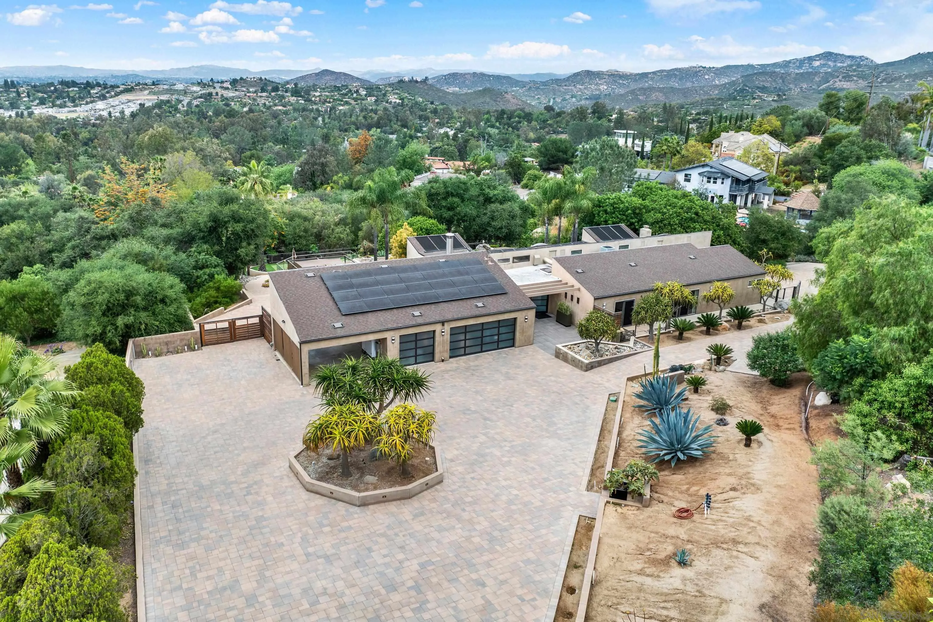 an aerial view of a house with a garden