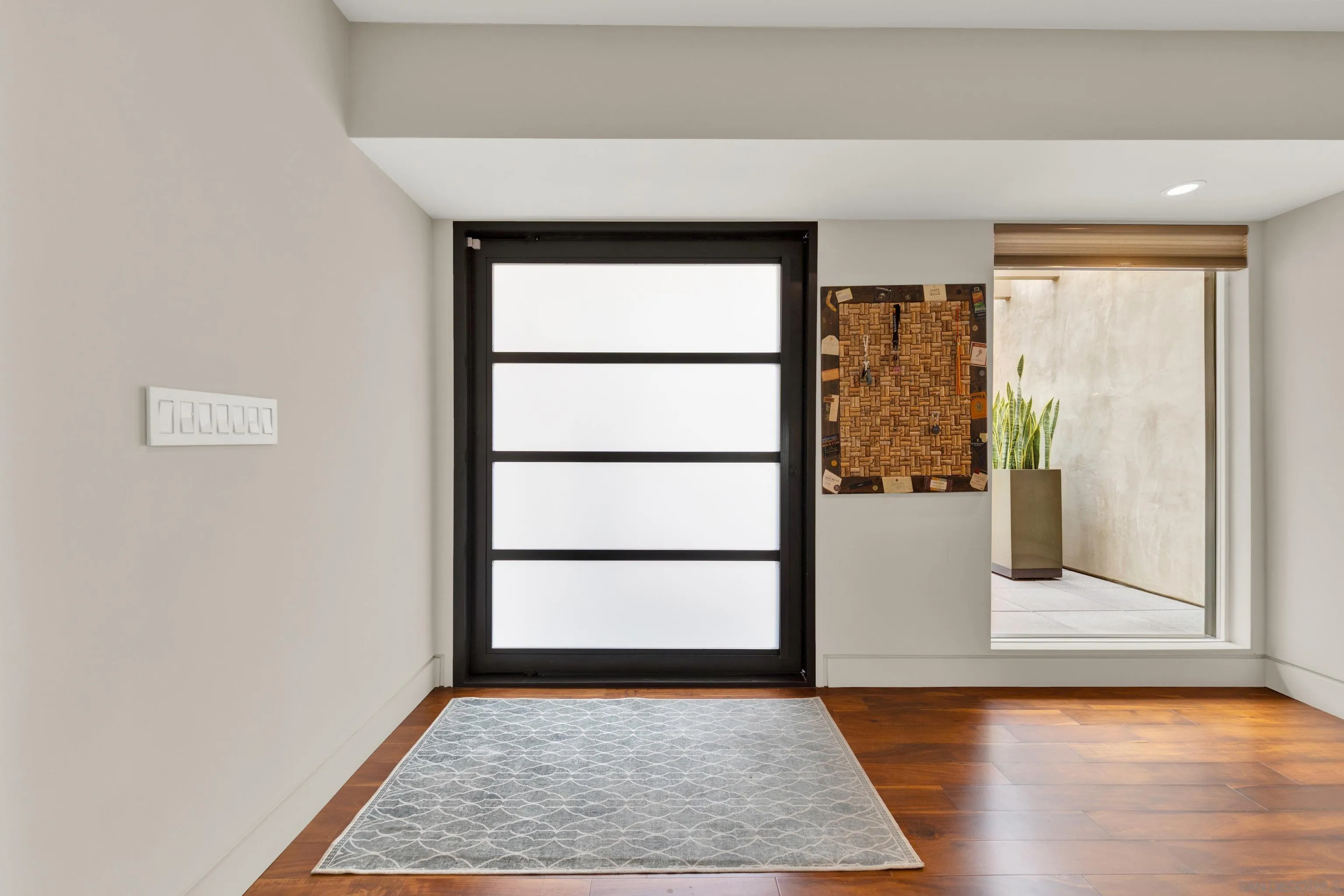 16117 Martincoit Road Poway, CA 92064 - Photo 6 of 73 a view of an empty room with wooden floor and a window