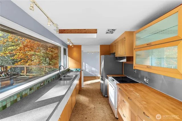 a view of a large kitchen with seating area