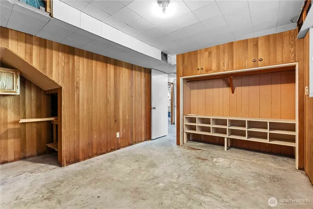 a view of an empty room with furniture and a window