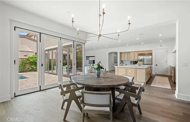 a dining room with furniture window and wooden floor