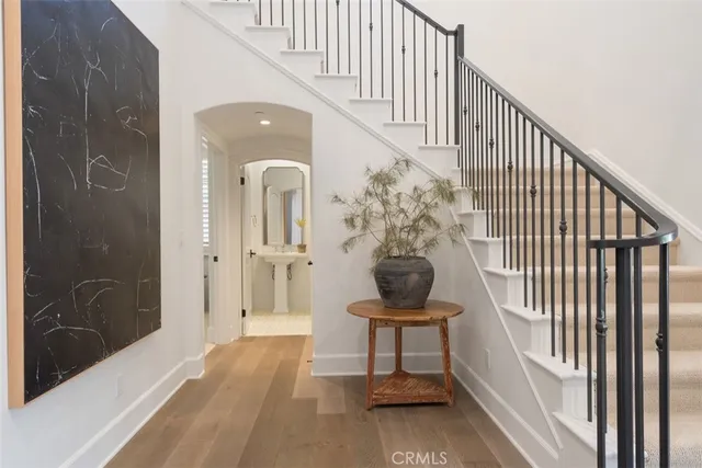 a view of a hallway with wooden floor and entryway