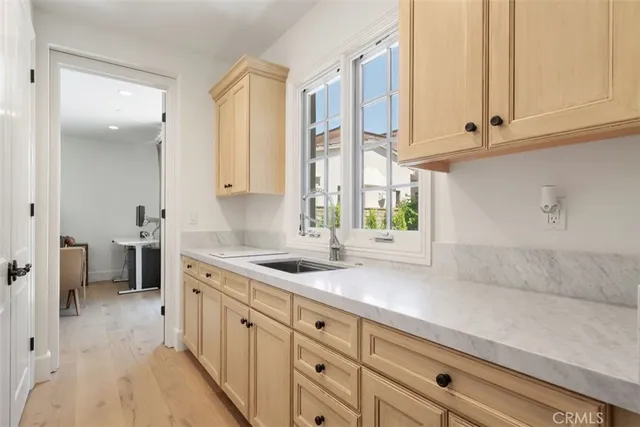 a kitchen with stainless steel appliances granite countertop a sink a stove and cabinets