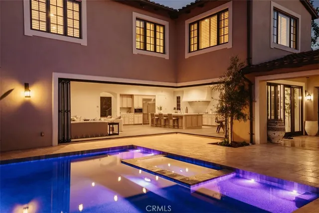 a swimming pool with outdoor seating and yard