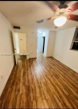 a view of a room with wooden floor