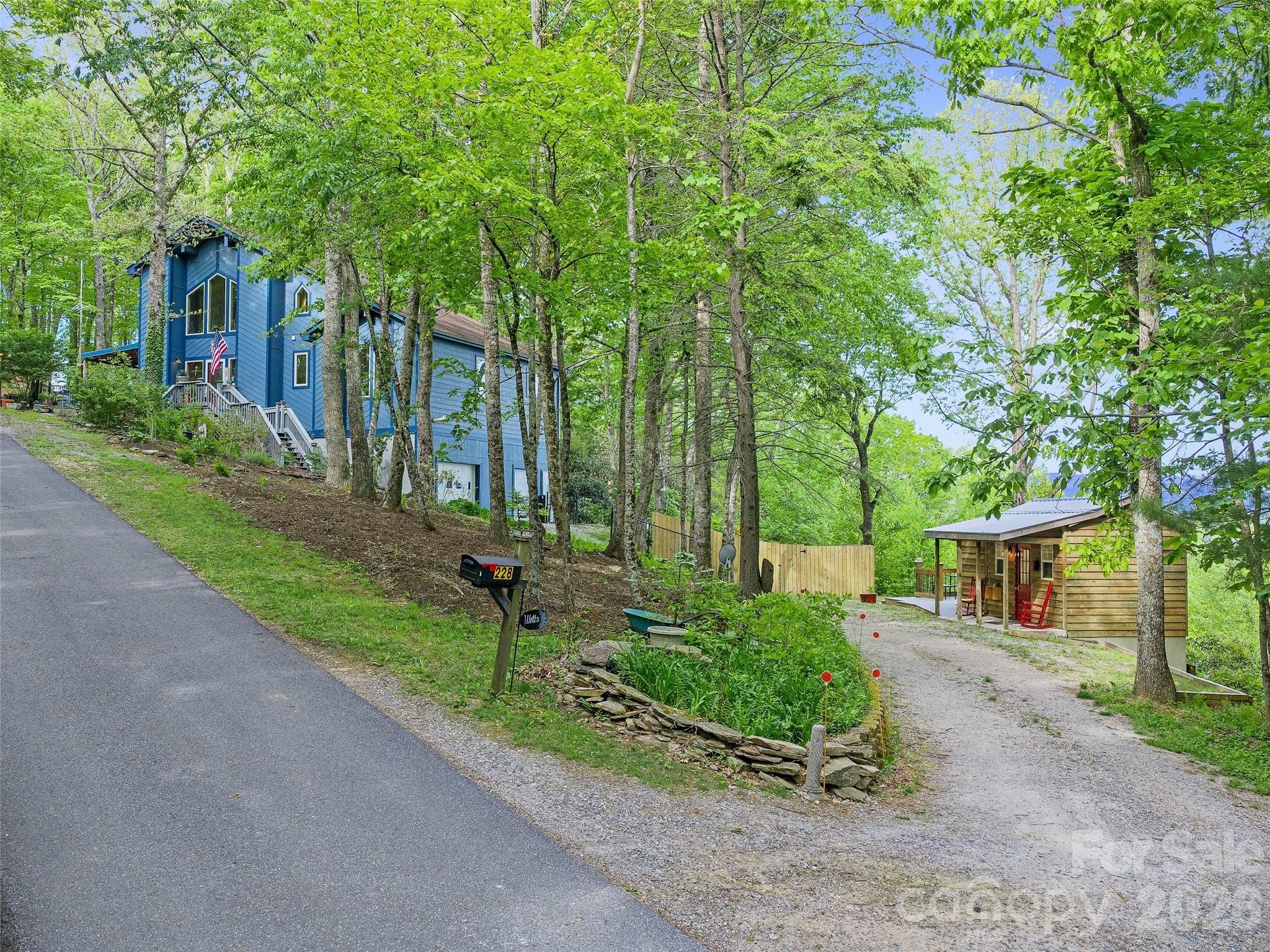 228 Continental Divide Road Spruce Pine, NC 28777 - Photo 35 of 48 front view of a house with a yard and potted plants