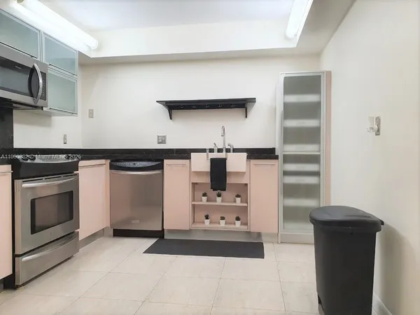 a kitchen with cabinets and appliances