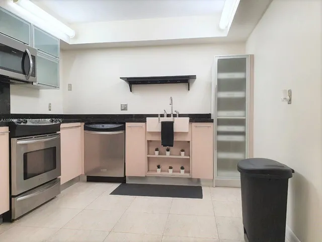 a kitchen with cabinets and appliances