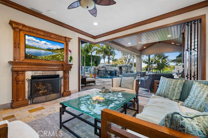 family room with cozy fireplace, expansive sliding doors that open up to back yard