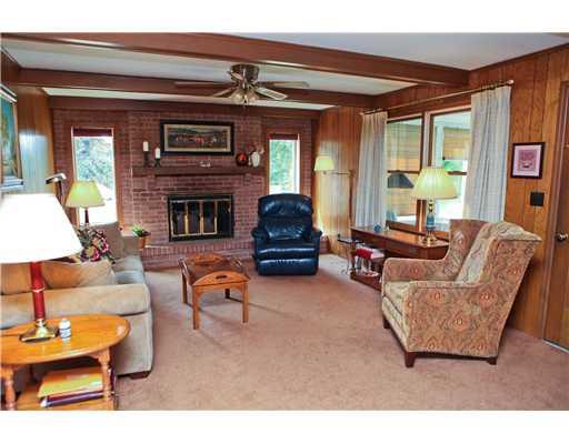118 Ridgeview Drive Venetia, PA 15367 - Photo 6 of 15 Family Room. Windows flank the floor to ceiling fireplace with a raised hearth, beamed ceiling and paddle fan. Door leads to the sunroom. Patio is off the sunroom.