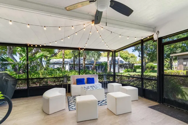 a balcony with furniture and a floor to ceiling window