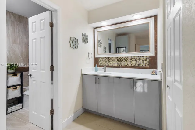 a bathroom with a sink and mirror