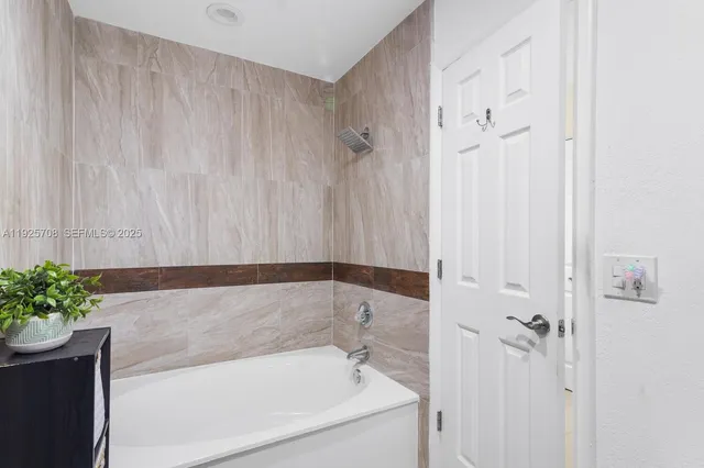 a bathroom with a bathtub and shower