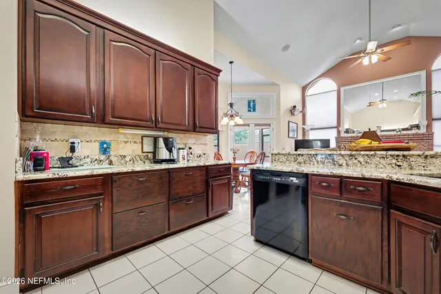 a kitchen with stainless steel appliances granite countertop wooden cabinets a sink and dishwasher