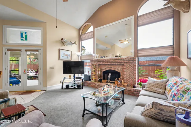 a living room with furniture a flat screen tv and a fireplace