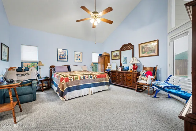 a bedroom with bed and a chandelier