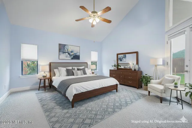a spacious bedroom with a bed and a chandelier