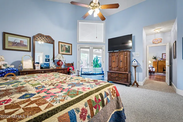 a bedroom with a bed and a flat screen tv