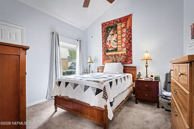 a bed sitting in a bedroom next to a window