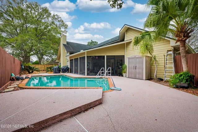 front view of house with a yard and potted plants