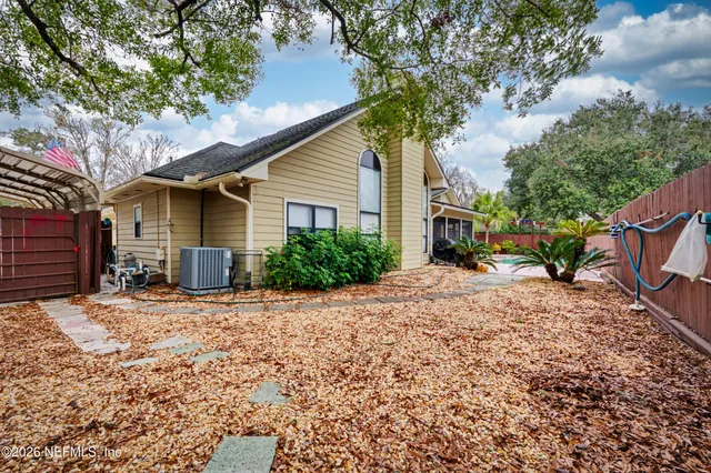 a backyard of a house with plants and tree