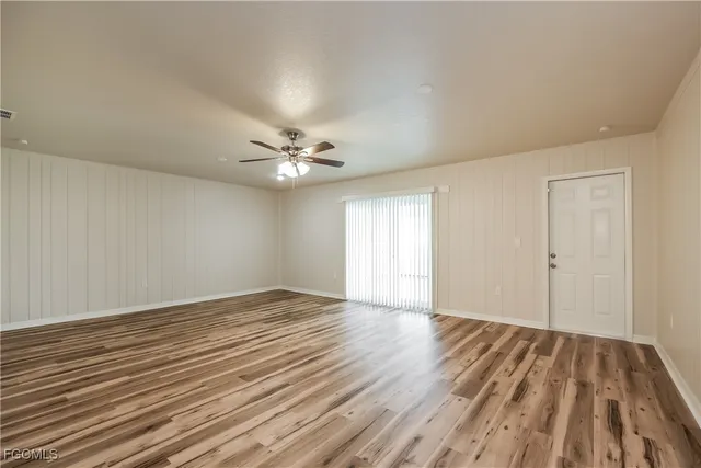 a view of an empty room and wooden floor