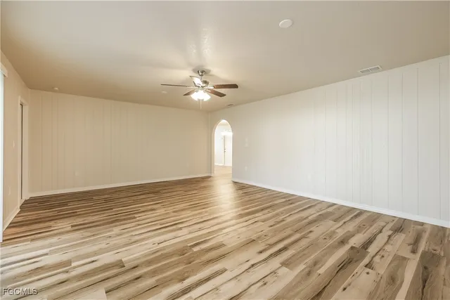a view of a room with wooden floor and fan