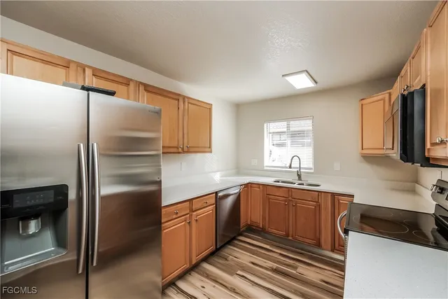a kitchen with a sink stainless steel appliances and cabinets