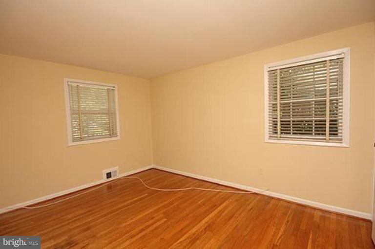 12707 Barbara Road Silver Spring, MD 20906 - Photo 15 of 21 a view of a room with wooden floor and windows
