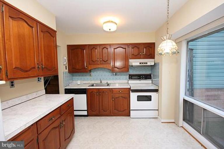 12707 Barbara Road Silver Spring, MD 20906 - Photo 5 of 21 a kitchen with stainless steel appliances granite countertop a stove sink and cabinets