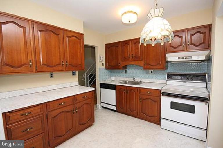 12707 Barbara Road Silver Spring, MD 20906 - Photo 7 of 21 a kitchen with granite countertop stainless steel appliances a stove refrigerator and cabinets